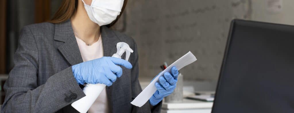 Professional cleaner cleaning office supplies